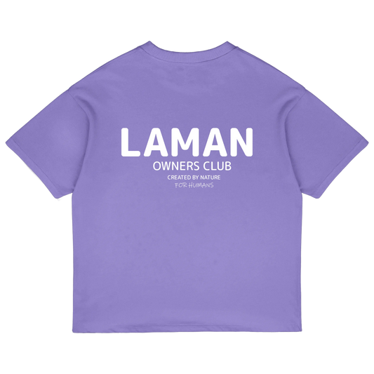 Olive green Laman Owners Club t-shirt with nature-inspired text, worn by man outdoors